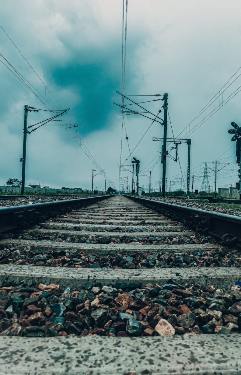 a railway track under a cloudy sky