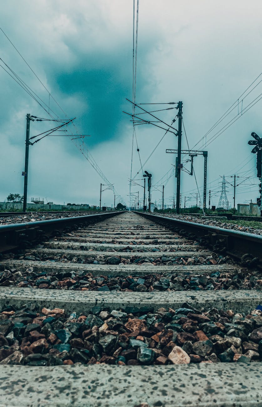 a railway track under a cloudy sky