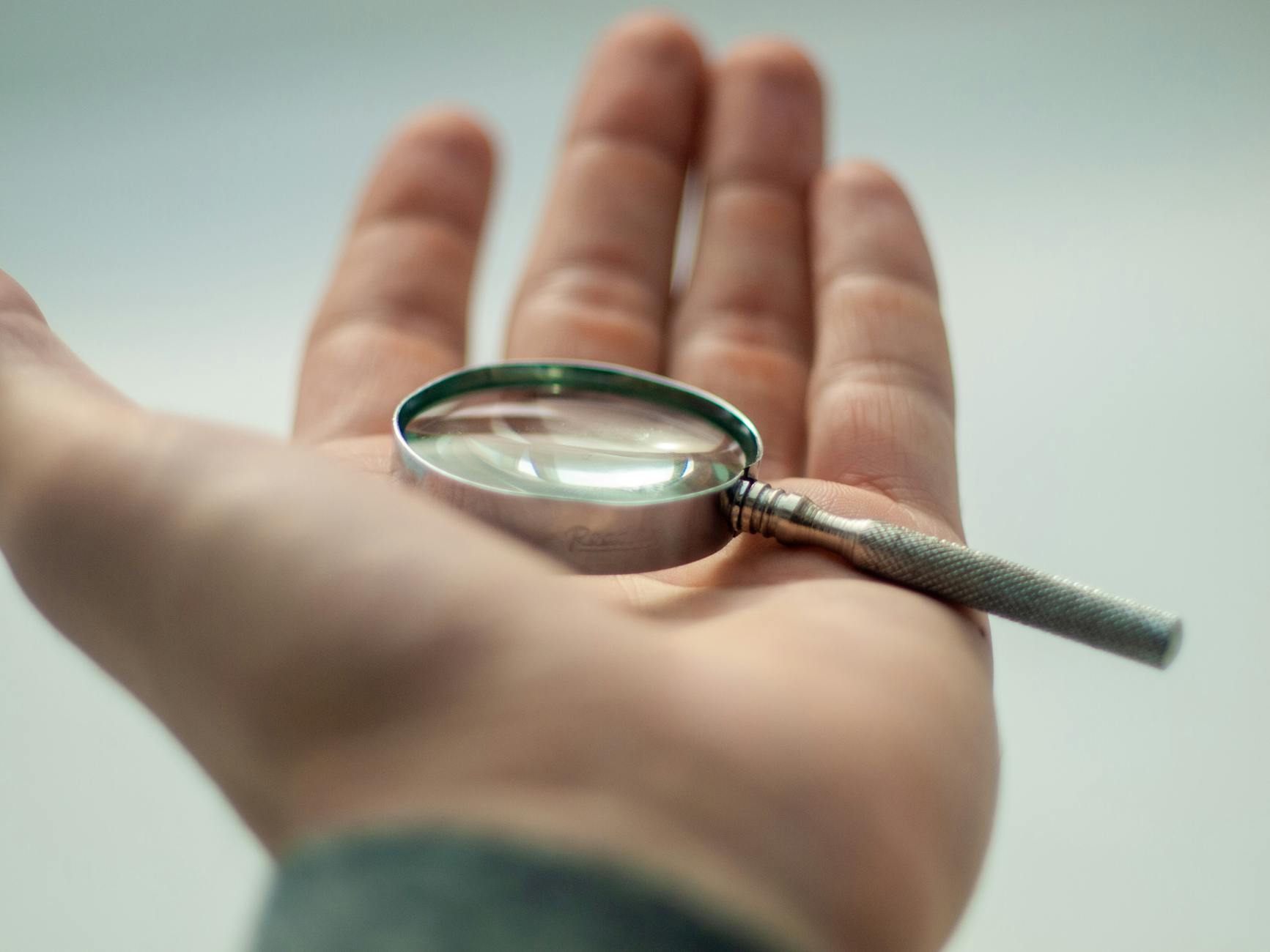 selective focus photo of magnifying glass