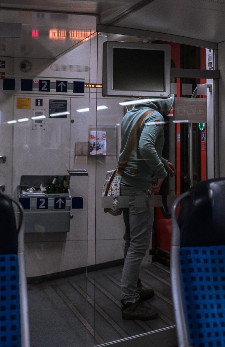 man standing in a modern train