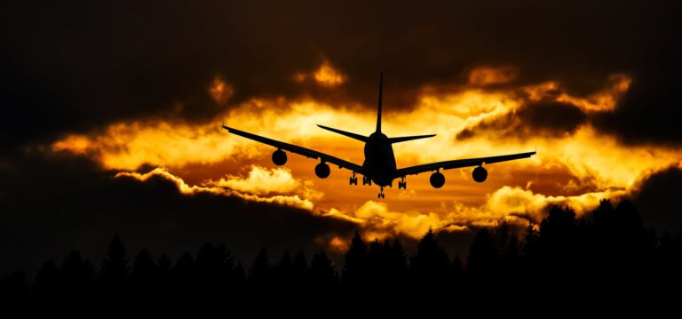 airplane silhouette on air during sunset