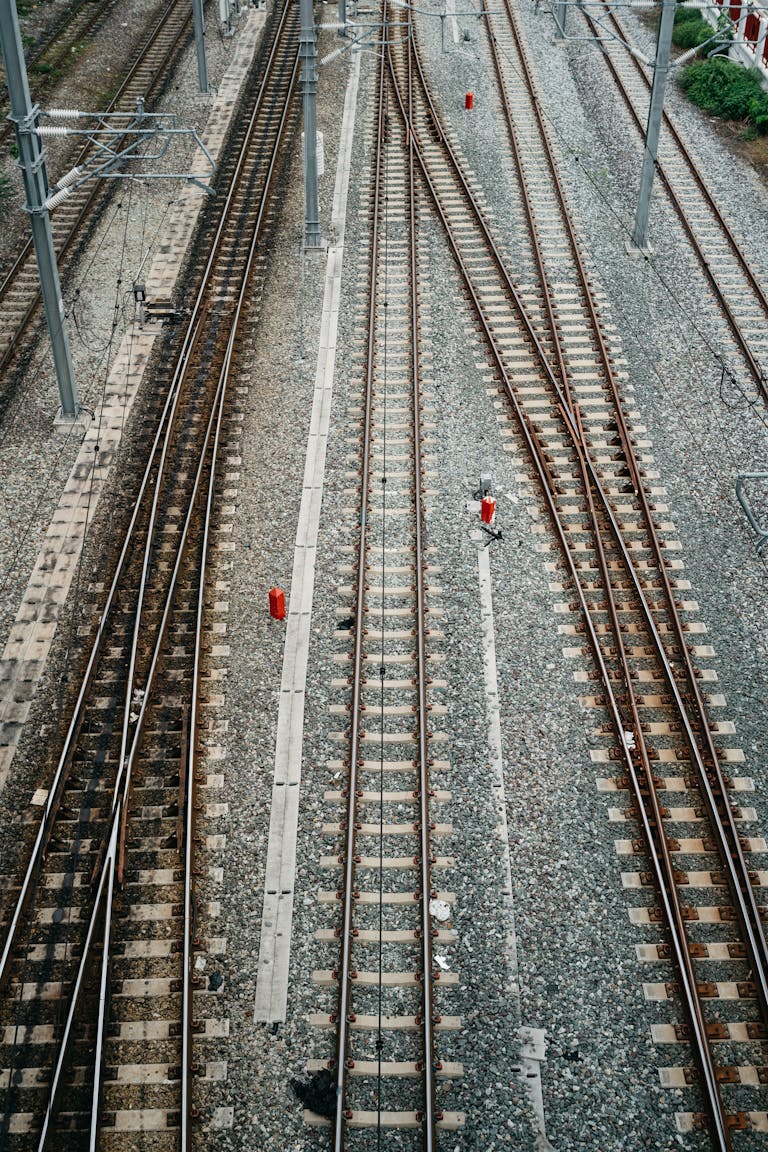 Aerial perspective of intersecting railway tracks in Bangkok, Thailand, highlighting urban transit.